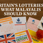 A variety of UK lottery tickets including EuroMillions, National Lottery, and People’s Postcode Lottery laid out on a wooden surface with British currency and a pen